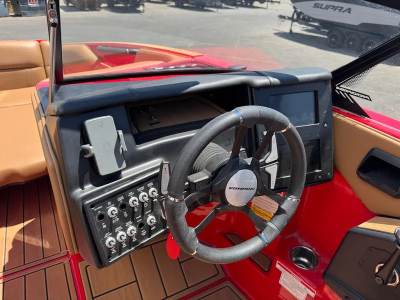 Slide: The Image of 2024 Moomba Craz boat dashboard with steering wheel and control panel. - 7