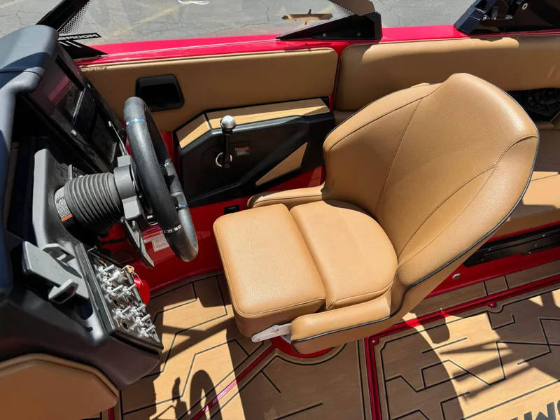 Slide: The Image of 2024 Moomba Craz boat interior with tan seat and steering wheel. - 8