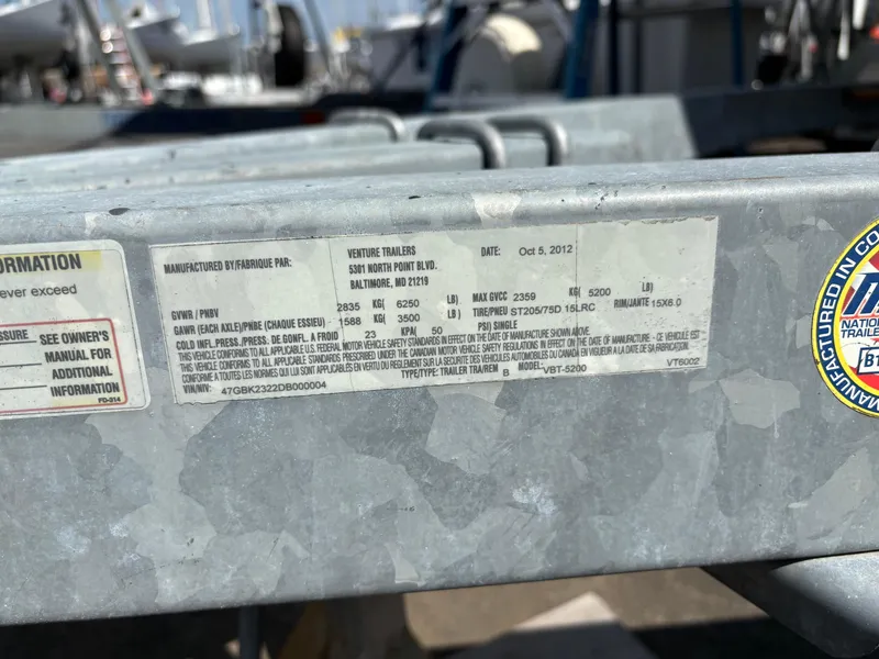 Slide: The Image of Trailer label with specifications and manufacturing details, including weight limits and tire information. - 13