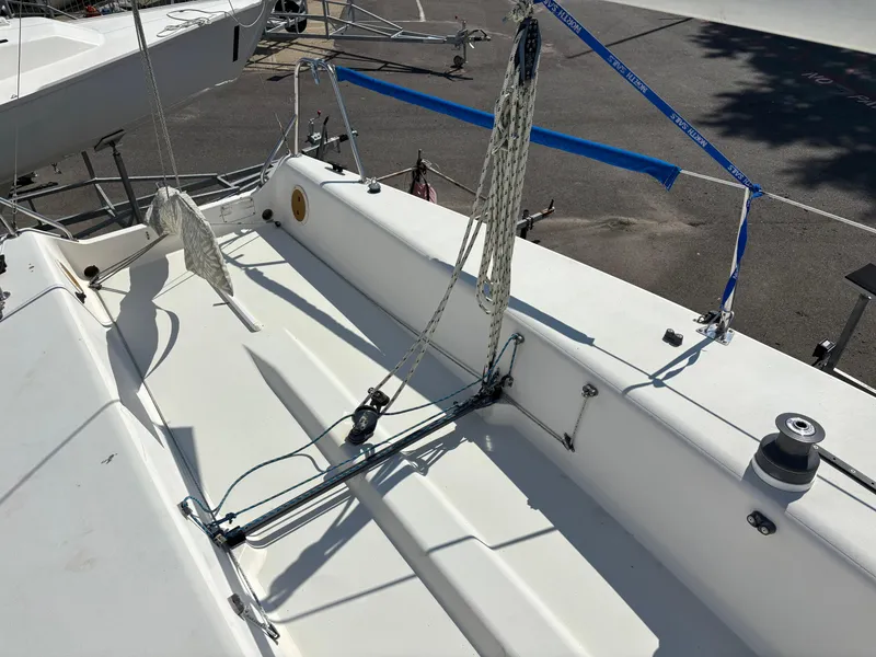 Slide: The Image of 1997 J Boats J/80 sailboat deck with rigging and winch in a marina setting. - 5