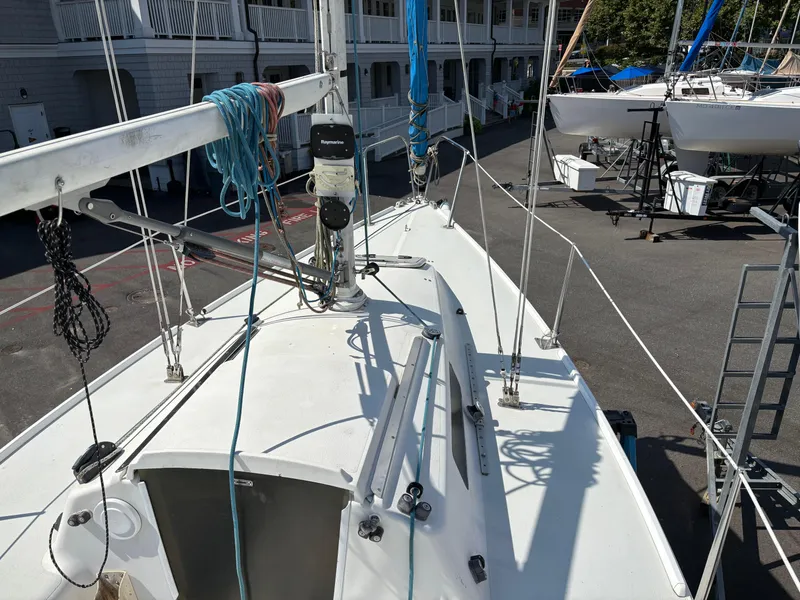 Slide: The Image of 1997 J Boats J/80 sailboat deck with rigging and ropes in a marina setting. - 7