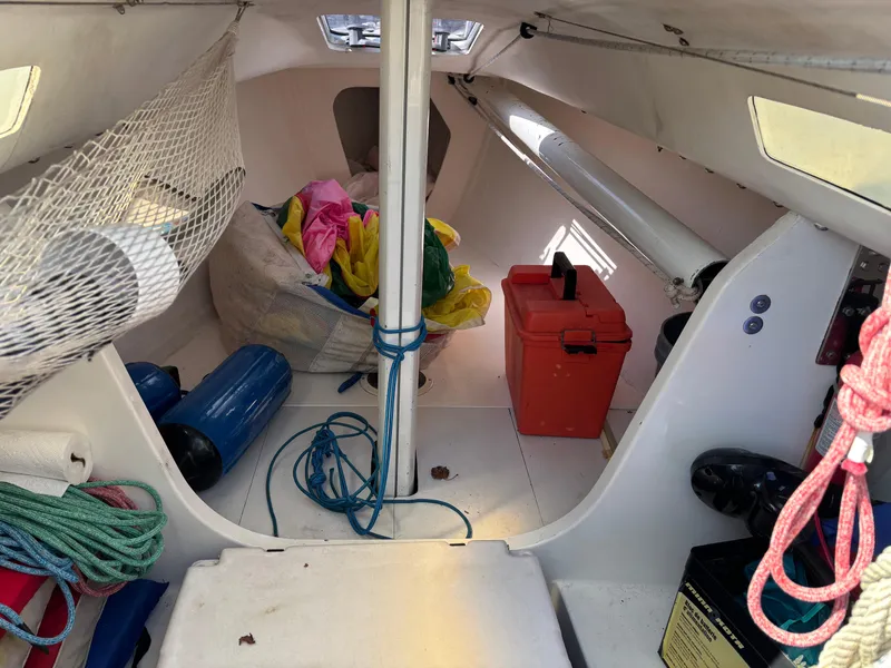 Slide: The Image of Interior of a 1997 J Boats J/80 sailboat with equipment and storage items. - 9