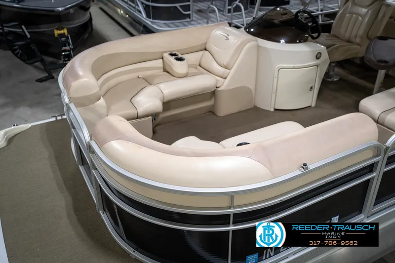 Slide: The Image of 2014 Bennington 2275GCW pontoon boat in indoor storage, featuring Yamaha outboard motor. - 11