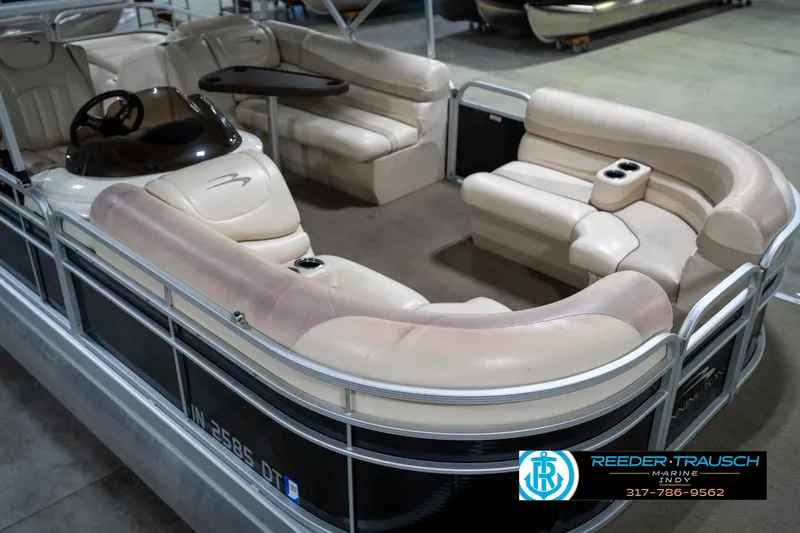 Slide: The Image of 2014 Bennington 2275GCW pontoon boat with beige seating and steering console. - 12