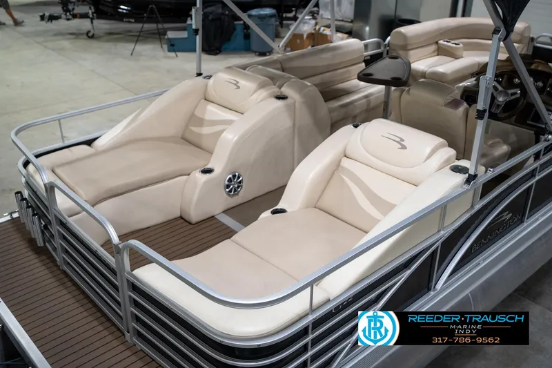 Slide: The Image of 2014 Bennington 2275GCW pontoon boat with beige seating and steering console. - 13