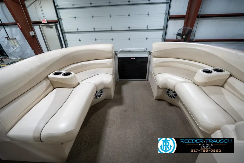 Slide: The Image of Interior of a 2014 Bennington 2275GCW pontoon boat with beige seating and wooden dashboard. - 20