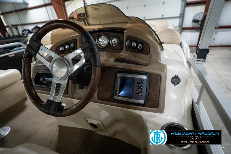 Slide: The Image of 2014 Bennington 2275GCW pontoon boat interior with beige seating and cup holders. - 21