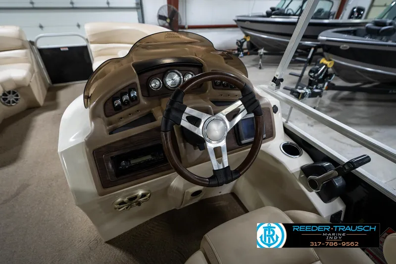Slide: The Image of 2014 Bennington 2275GCW pontoon boat interior with beige seating and cup holders. - 22