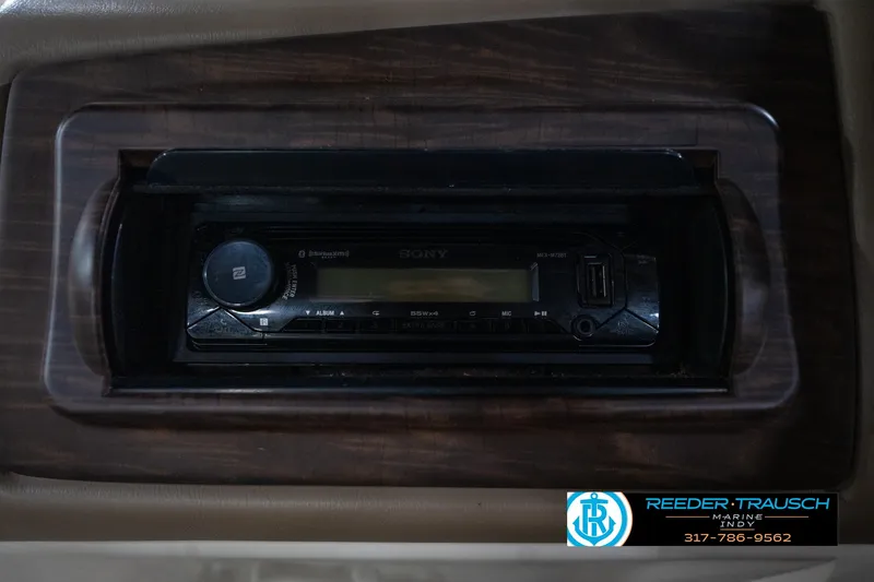 Slide: The Image of 2014 Bennington 2275GCW pontoon boat interior with storage compartment and cup holders. - 23