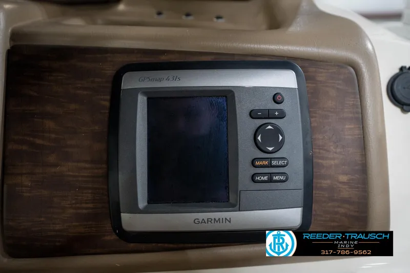 Slide: The Image of 2014 Bennington 2275GCW boat interior with beige seating in a showroom. - 24