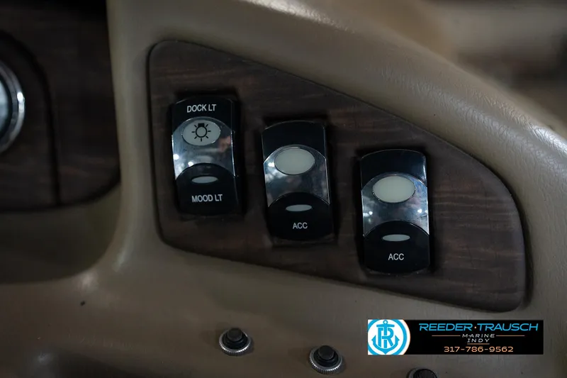 Slide: The Image of 2014 Bennington 2275GCW boat interior with beige seating and storage compartments. - 25