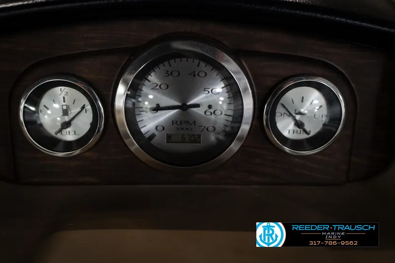 Slide: The Image of 2014 Bennington 2275GCW pontoon boat interior with beige seating and wooden table. - 26