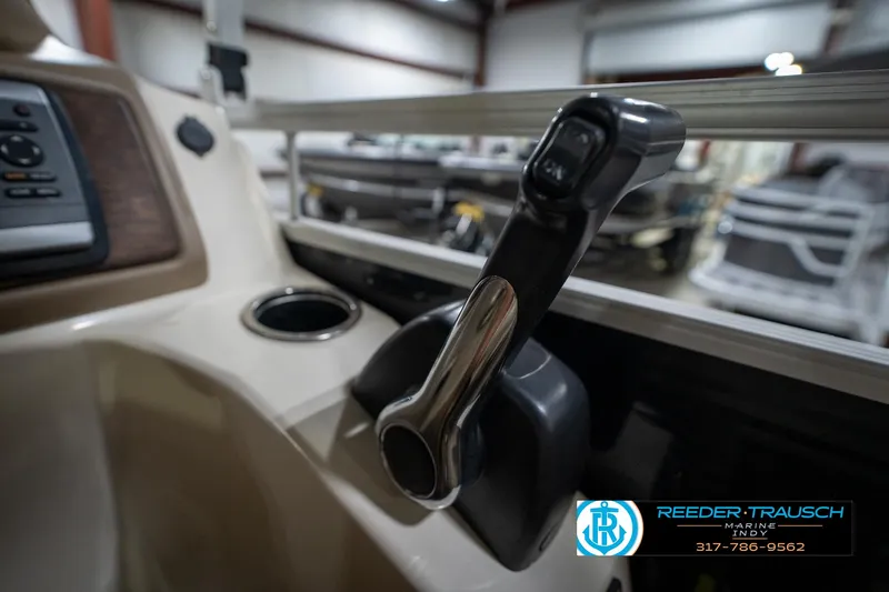 Slide: The Image of 2014 Bennington 2275GCW pontoon boat with beige seating in a showroom. - 29