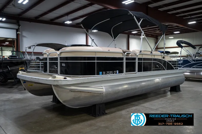 Slide: The Image of 2014 Bennington 2275GCW pontoon boat in indoor showroom, featuring sleek design and sturdy build. - 3