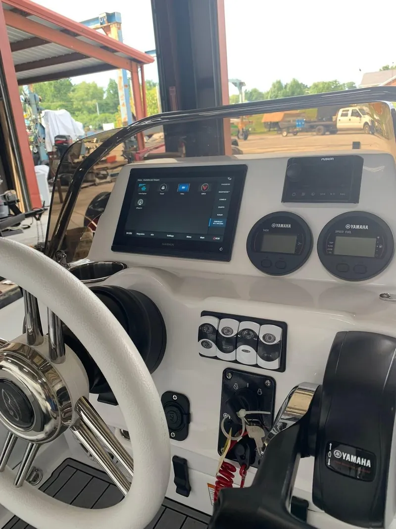 Slide: The Image of 2021 Walker Bay Venture 14 dashboard with steering wheel and Yamaha controls. - 6