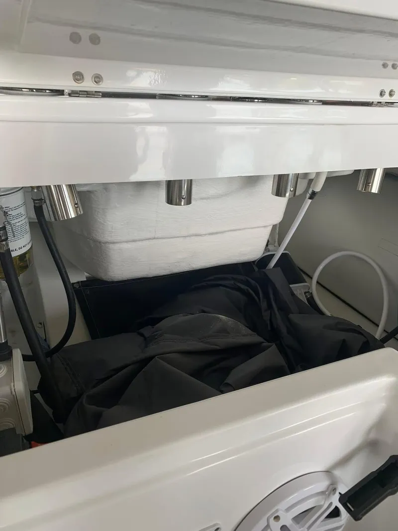 Slide: The Image of 2021 Walker Bay Venture 14 interior compartment with storage and equipment. - 7