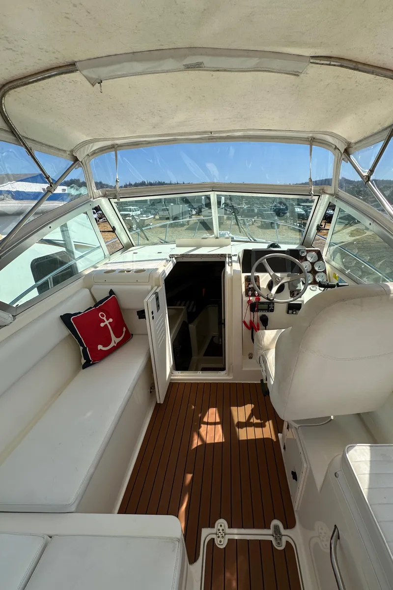 Slide: The Image of 2002 Pursuit 2860 Denali boat interior with helm, seating, and nautical decor. - 19