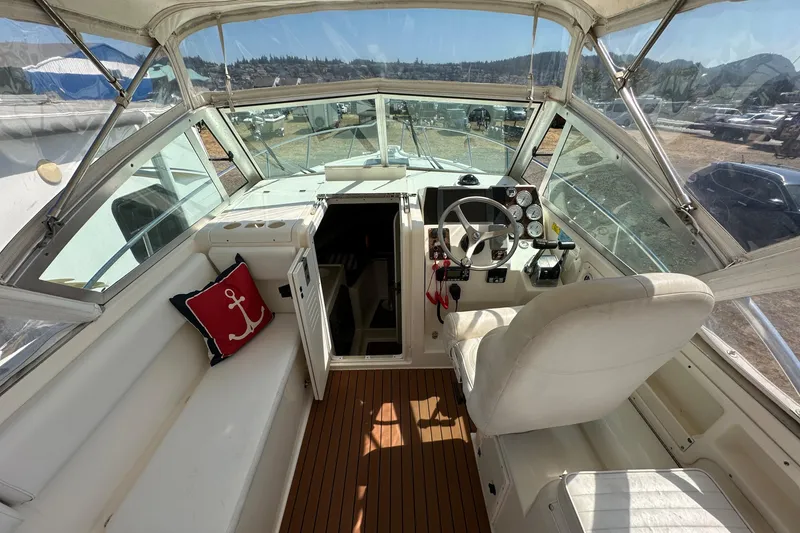 Slide: The Image of 2002 Pursuit 2860 Denali boat interior with helm, seating, and nautical decor. - 20