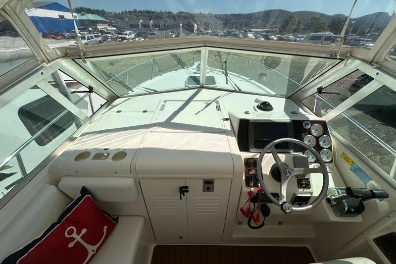 Slide: The Image of 2002 Pursuit 2860 Denali boat cockpit with steering wheel, gauges, and navigation equipment. - 23