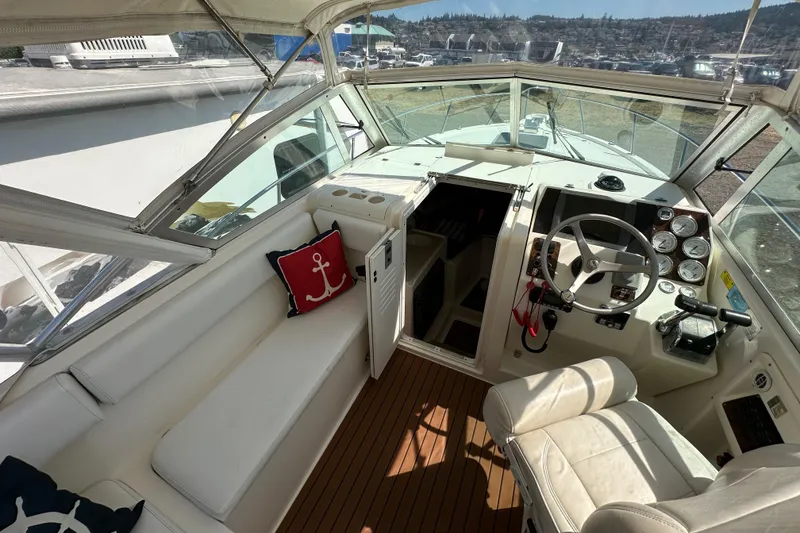 Slide: The Image of 2002 Pursuit 2860 Denali boat interior with helm, seating, and nautical decor. - 24