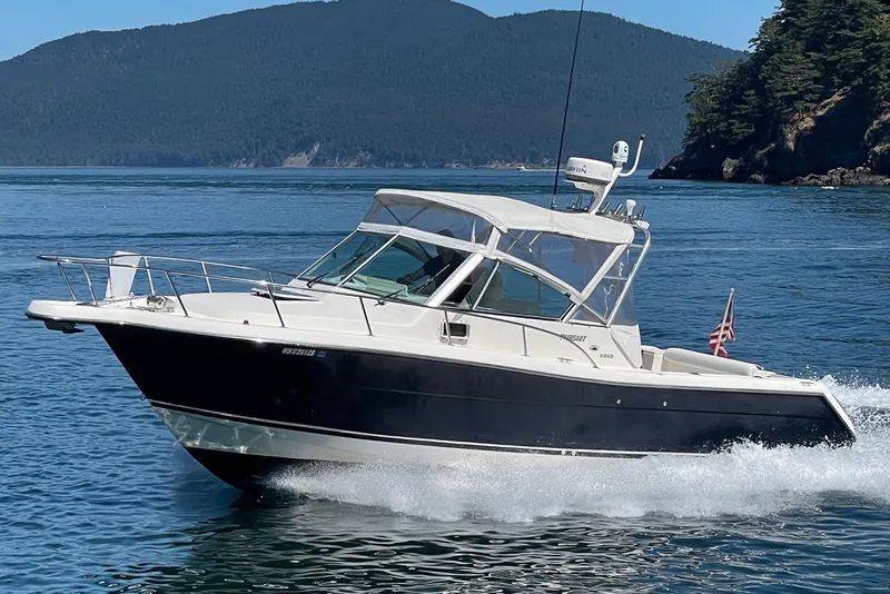 Slide: The Image of 2002 Pursuit 2860 Denali boat cruising on scenic blue waters. - 30