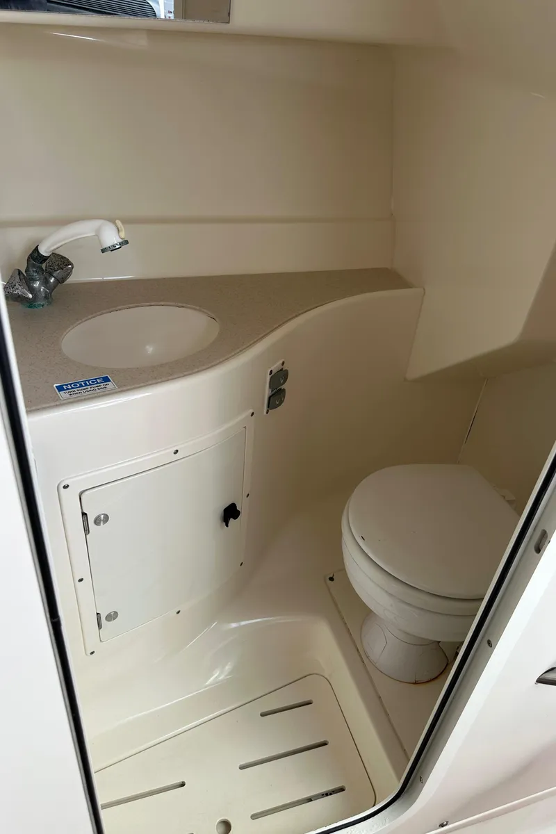 Slide: The Image of 2002 Pursuit 2860 Denali boat bathroom with sink and toilet. - 38