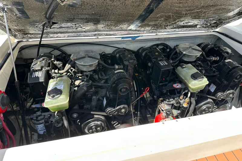 Slide: The Image of Engine compartment of a 2002 Pursuit 2860 Denali boat, showcasing dual engines. - 39