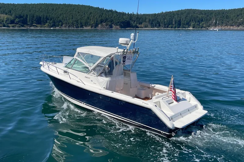 Slide: The Image of 2002 Pursuit 2860 Denali boat on water, for sale, with American flag. - 4