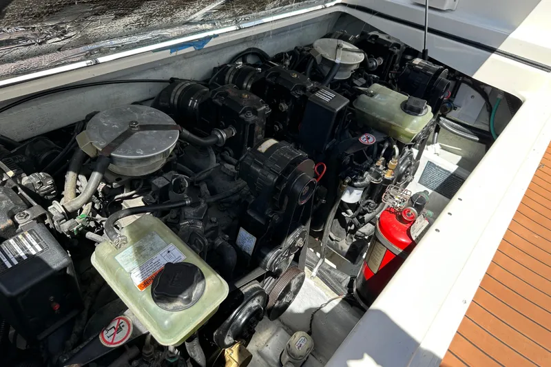 Slide: The Image of Engine compartment of a 2002 Pursuit 2860 Denali boat, featuring dual engines and a fire extinguisher. - 40