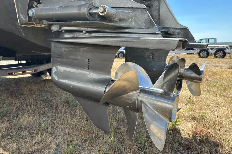 Slide: The Image of Close-up of 2002 Pursuit 2860 Denali boat propellers on dry grass. - 43