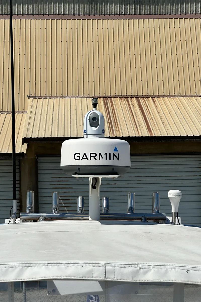 Slide: The Image of Garmin radar on 2002 Pursuit 2860 Denali boat, docked near industrial building. - 45