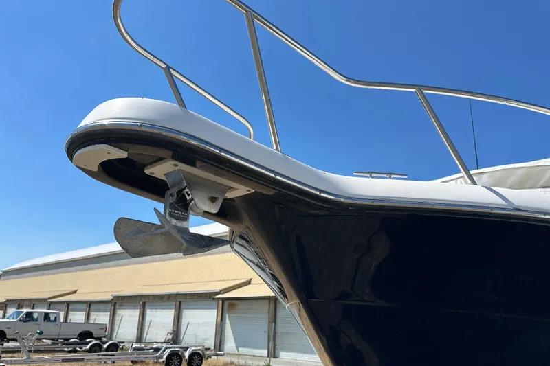 Slide: The Image of 2002 Pursuit 2860 Denali boat bow with anchor, clear blue sky background. - 49
