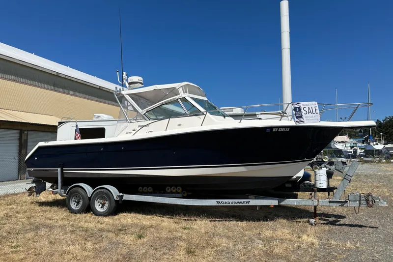 Slide: The Image of 2002 Pursuit 2860 Denali boat on trailer, for sale sign visible. - 52