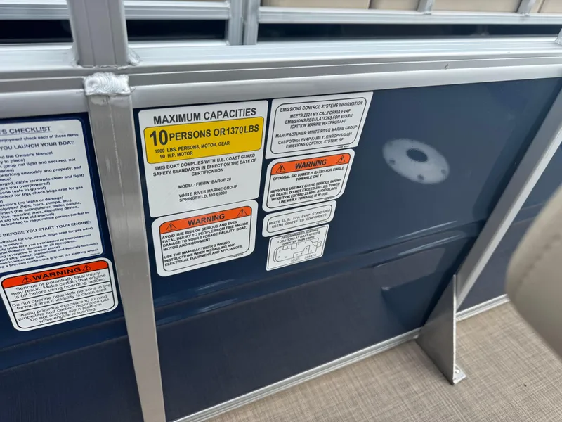 Slide: The Image of 2024 Sun Tracker Fishin' Barge 20 DLX capacity and safety warning labels. - 13