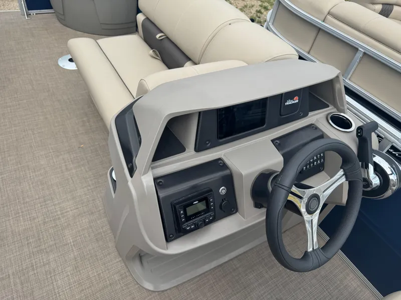 Slide: The Image of 2024 Sun Tracker Fishin' Barge 20 DLX dashboard with steering wheel and controls. - 17