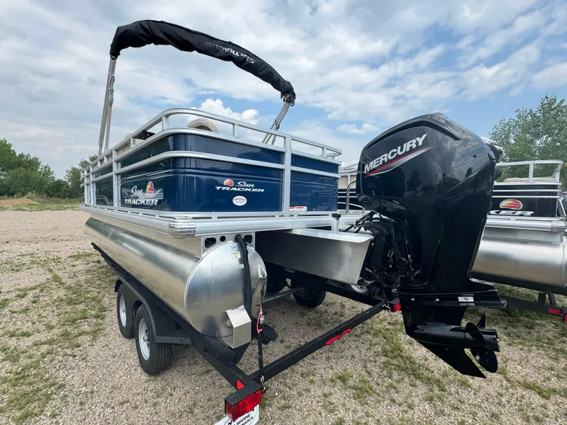 Slide: The Image of 2024 Sun Tracker Fishin' Barge 20 DLX with Mercury engine on trailer. - 4