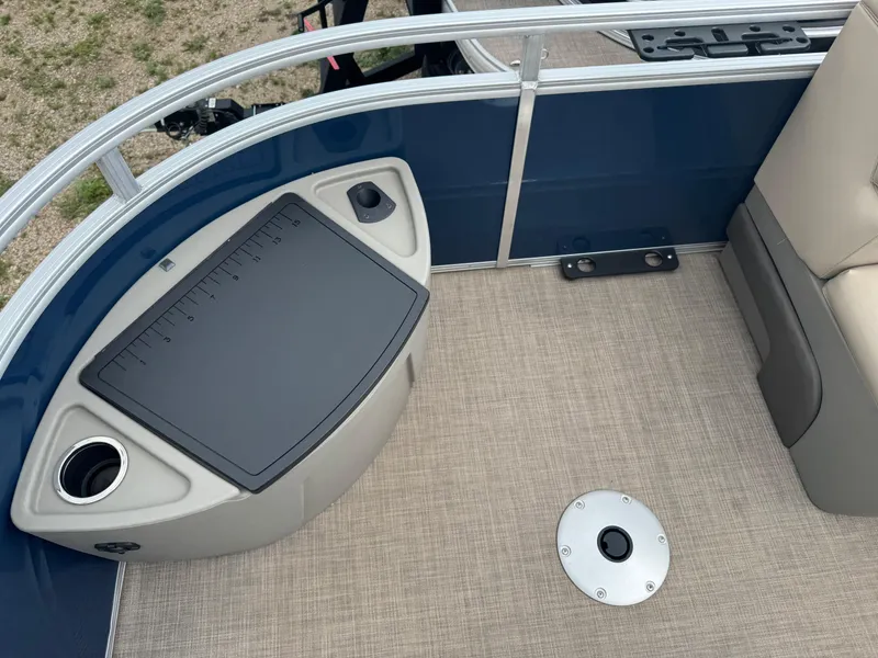 Slide: The Image of 2024 Sun Tracker Fishin' Barge 20 DLX interior with fishing station and cup holder. - 6