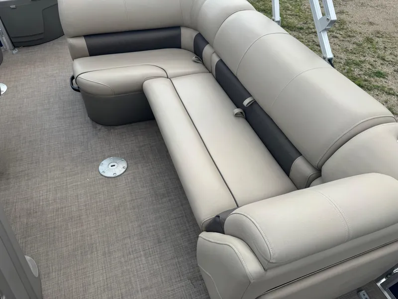 Slide: The Image of 2024 Sun Tracker Fishin' Barge 20 DLX interior seating with beige upholstery. - 9