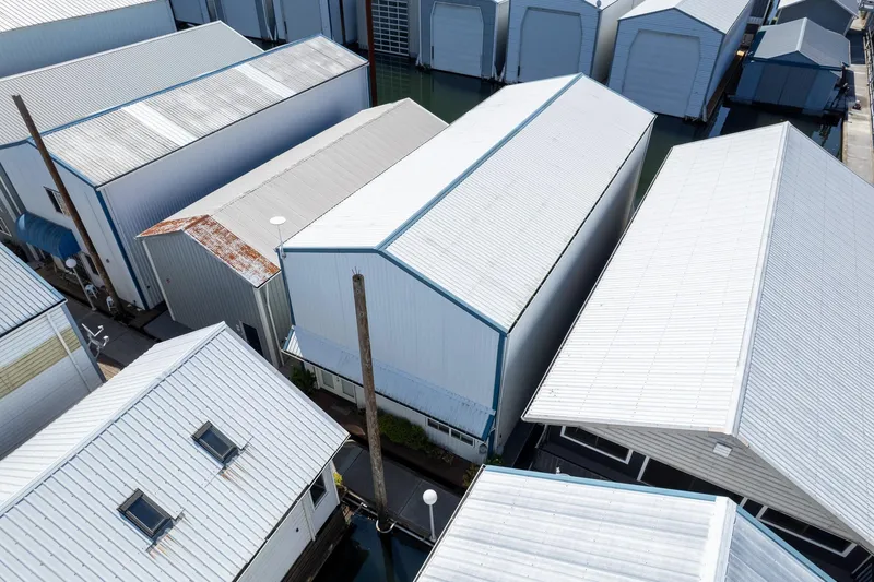 Slide: The Image of Aerial view of Steelhead Boathouse, 2006, featuring multiple white-roofed structures. - 10