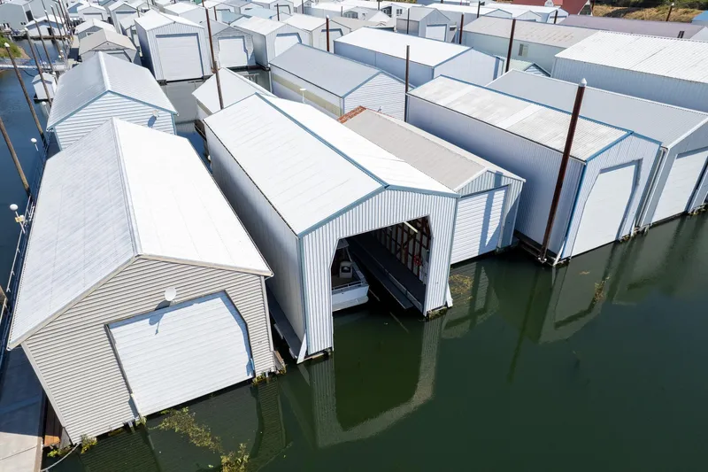 Slide: The Image of Aerial view of Steelhead Boathouse, 2006, with multiple boat storage units on water. - 12