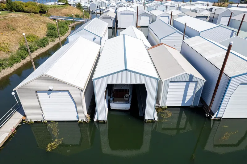 Slide: The Image of Aerial view of Steelhead Boathouse, 2006, with boat docked inside, surrounded by water. - 13