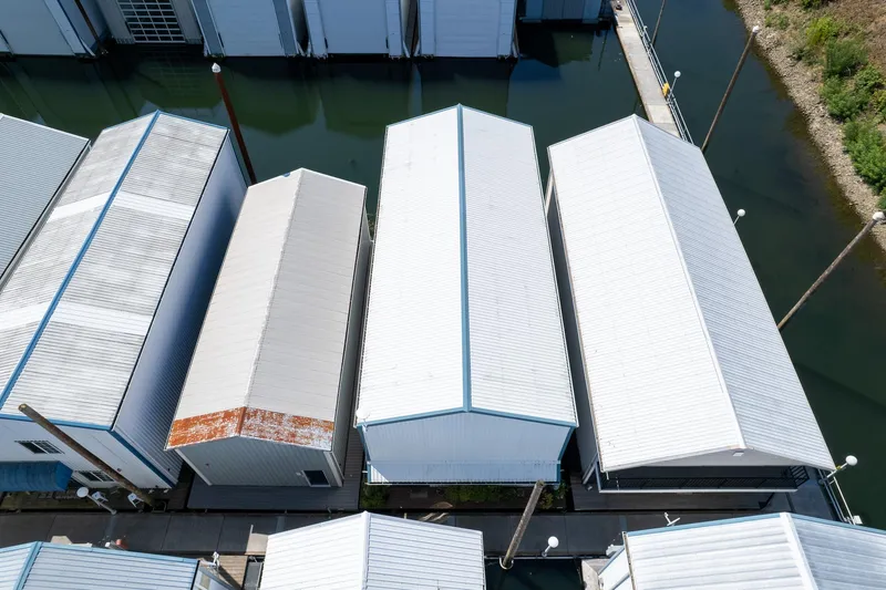 Slide: The Image of Aerial view of Steelhead Boathouse, 2006, with white roofs and water reflections. - 14
