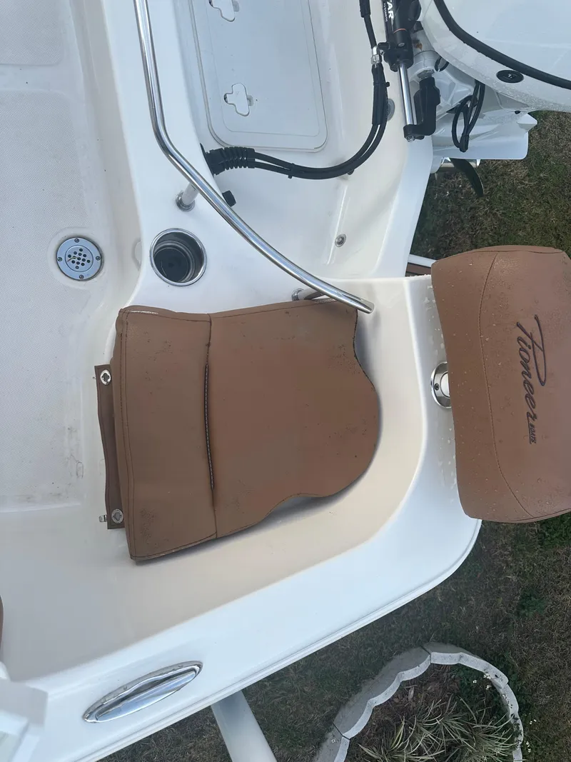 Slide: The Image of 2024 Pioneer 202 Sportfish boat interior with tan seating and white deck. - 19