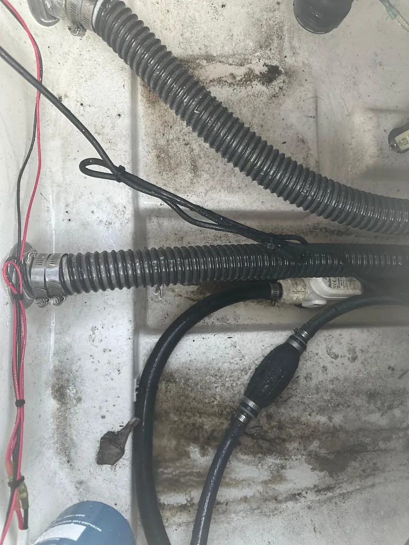 Slide: The Image of Close-up of wiring and hoses in a 2024 Pioneer 202 Sportfish boat. - 21