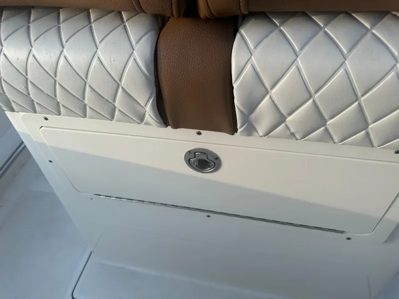 Slide: The Image of 2024 Pioneer 202 Sportfish seat detail with quilted upholstery and storage compartment. - 32