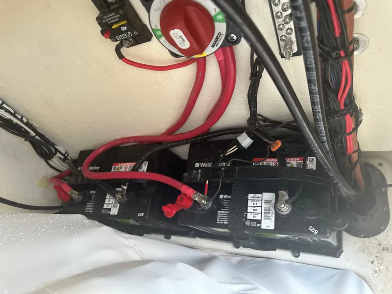 Slide: The Image of Battery compartment of 2024 Pioneer 202 Sportfish boat with wiring and connections. - 35
