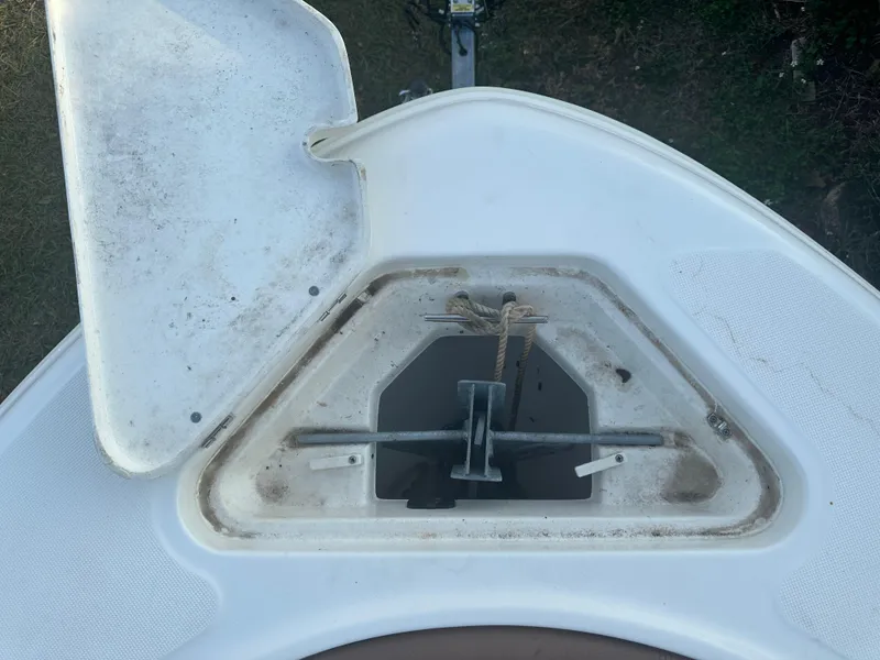 Slide: The Image of 2024 Pioneer 202 Sportfish anchor compartment with open hatch, showcasing storage area. - 40