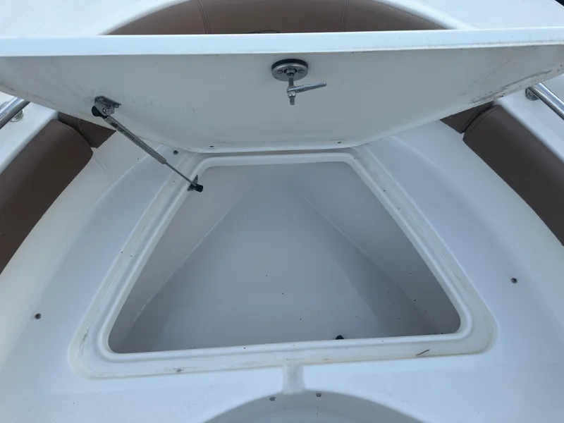 Slide: The Image of Open storage compartment on 2024 Pioneer 202 Sportfish boat. - 42