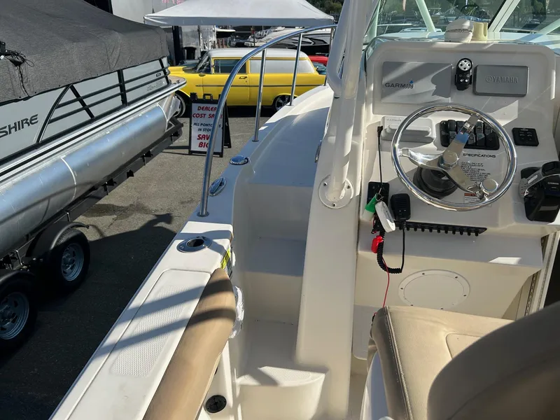 Slide: The Image of 2020 Sailfish 220 WAC boat interior with steering wheel and control panel. - 10