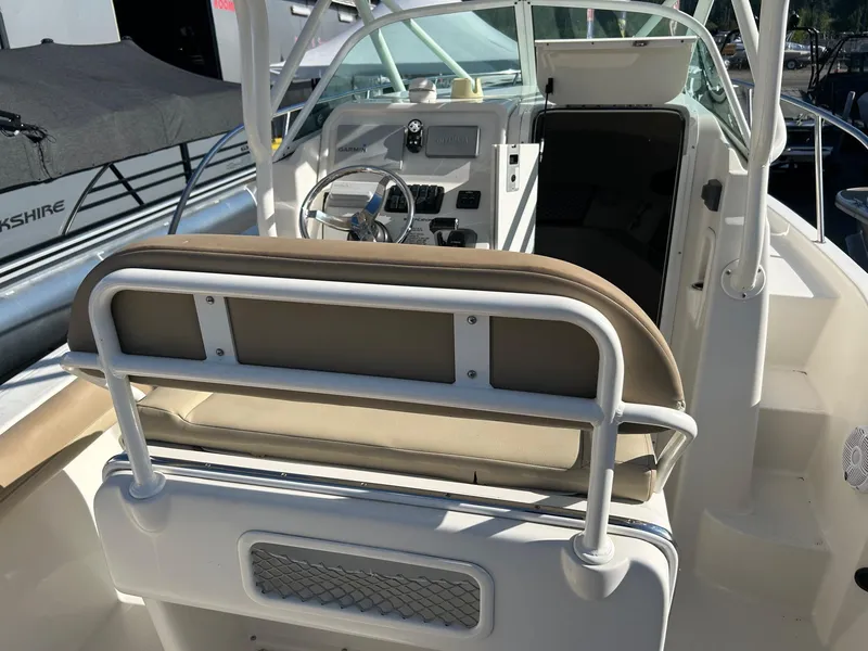 Slide: The Image of 2020 Sailfish 220 WAC boat interior with helm and seating area. - 11
